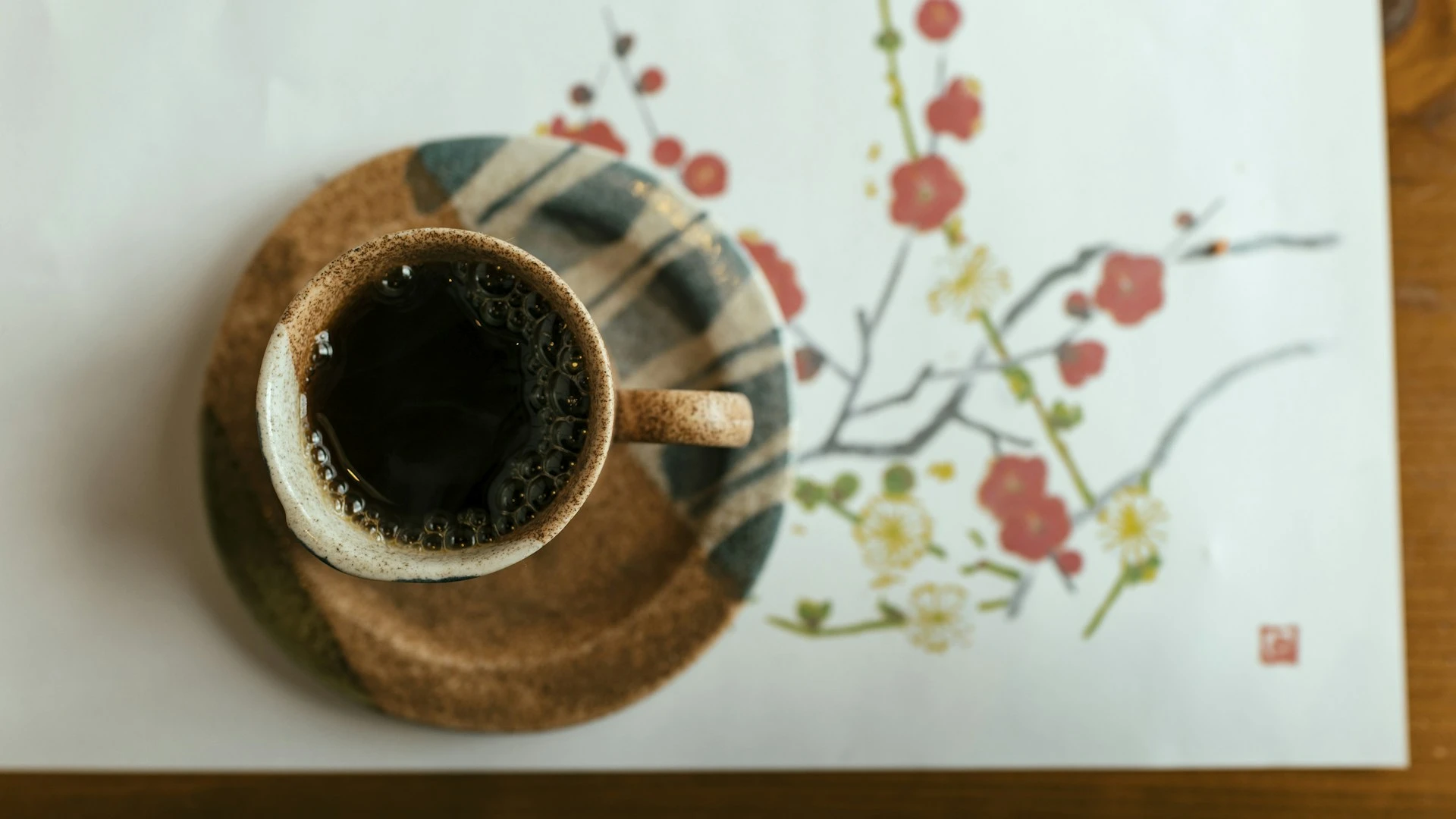 白瓷咖啡杯與咖啡豆擺在淺色桌面，公平貿易最常見的品項