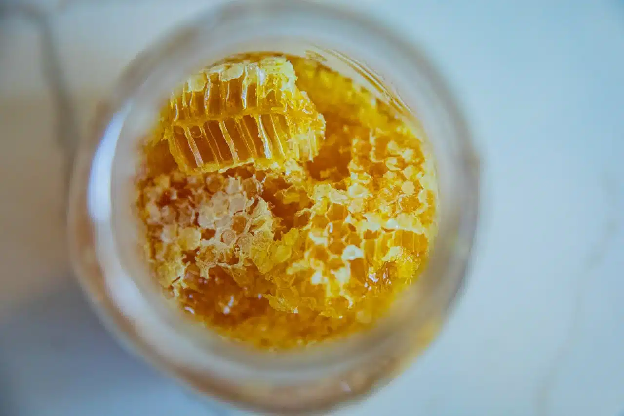 玻璃罐裡的天然蜂巢與蜂蜜，挑蜂蜜泡蜂蜜水以純正無添加為佳